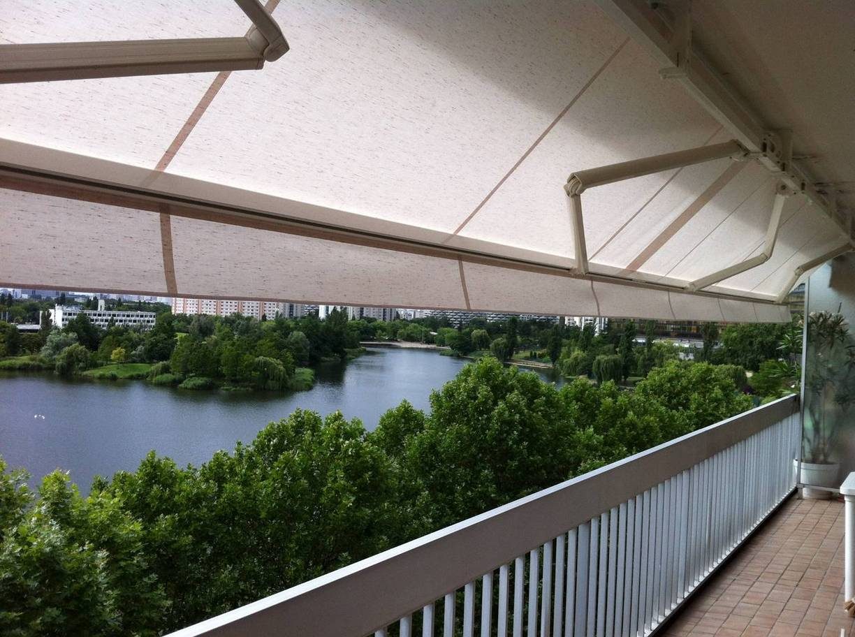 Store banne coffre déployé sur une terrasse avec vue sur un parc — EloxyMetal